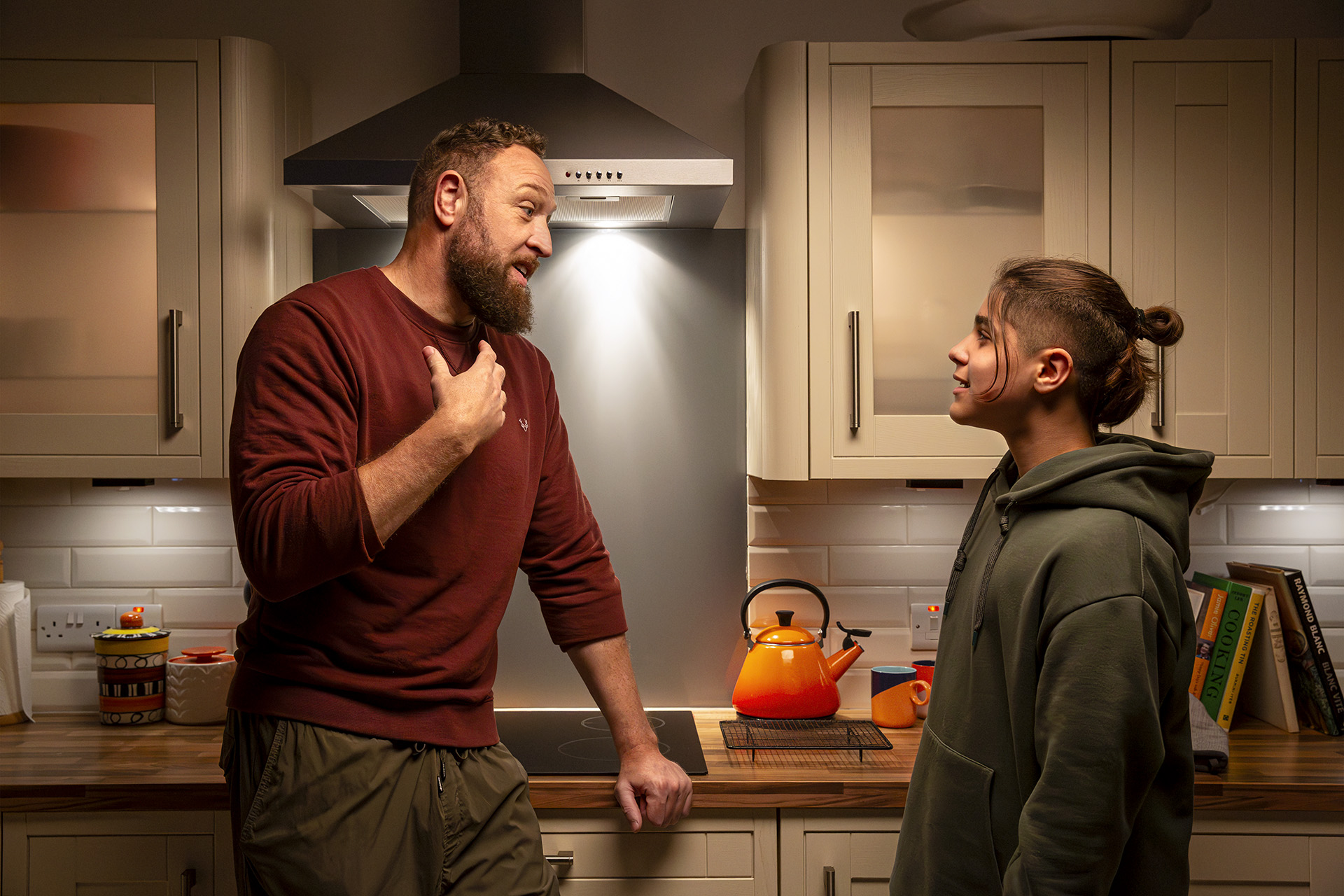 Man and teenage boy in kitchen